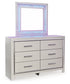 Zyniden Queen Upholstered Panel Headboard with Mirrored Dresser and Chest